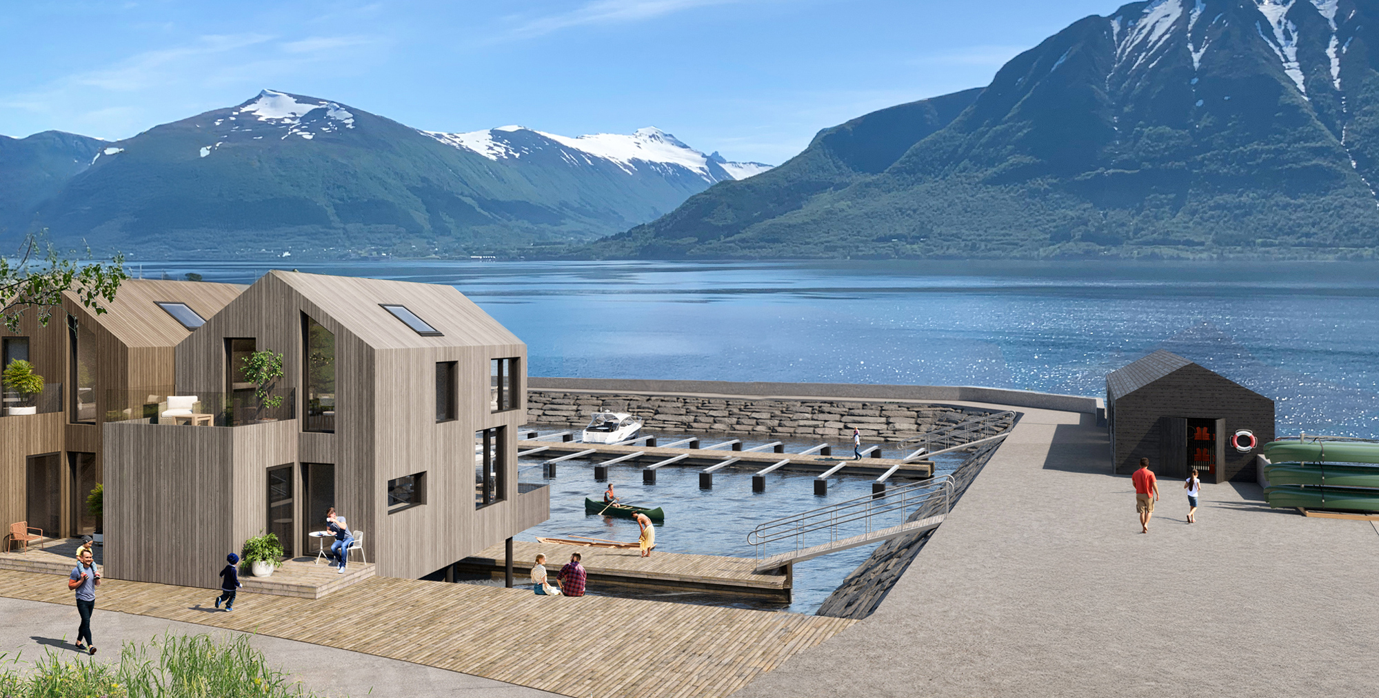 Flere moderne hytter på Almestranda, plassert i kanten av fjorden, med utsikt mot fjord og fjell i bakgrunnen.